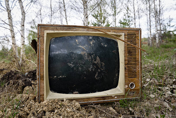 istock Old analog discarded television set in the forest 528922306