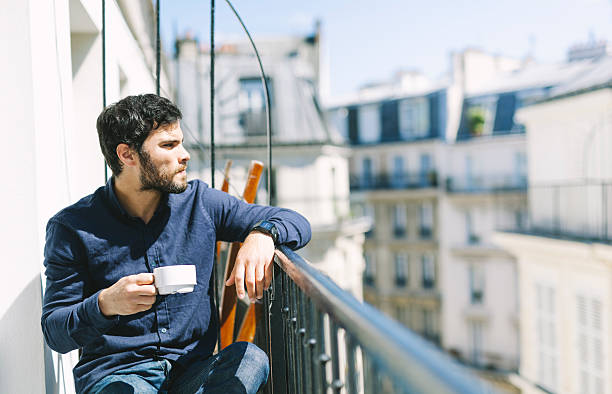 istock Handsome Man Enjoying Coffee Sitting in a Balcony 528922322