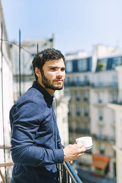 istock Handsome Dark Hair Man Drinking Coffee Outdoors in a Balcony 528922402
