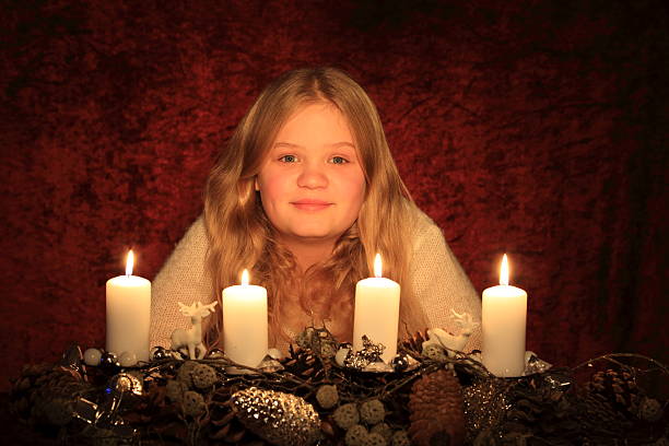 young blond girl with Advent wreath stock photo
