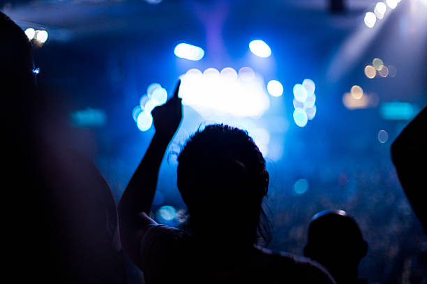 istock girl dancing at rock concert 528927453
