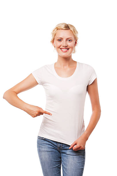 istock Smiling woman pointing at blank white t-shirt 528931271