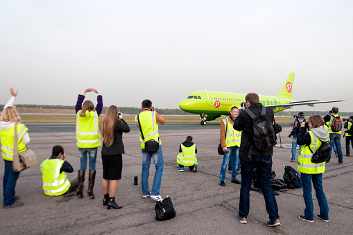 Moscow, Russia - September 26, 2014: Spotters on the platform of the airport Domodedovo. Moscow Domodedovo Airport organizes regular spotting on its territory.