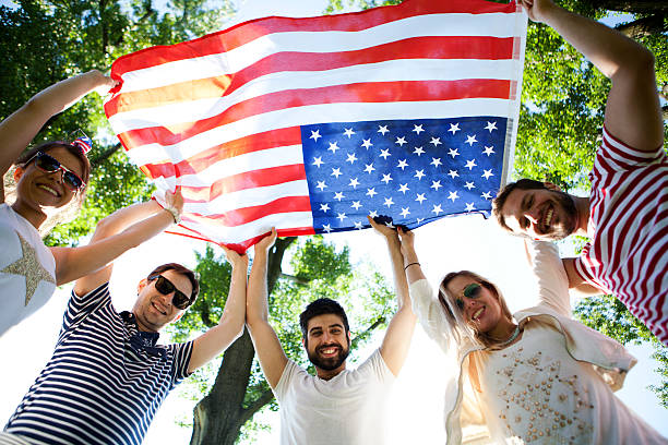 istock Friends holding American flag 528954336