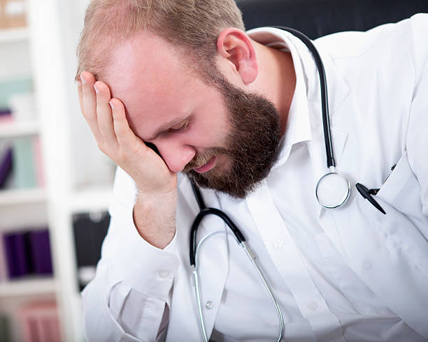 istock Doctor is overworked and sits at his desk in his practice 528954359