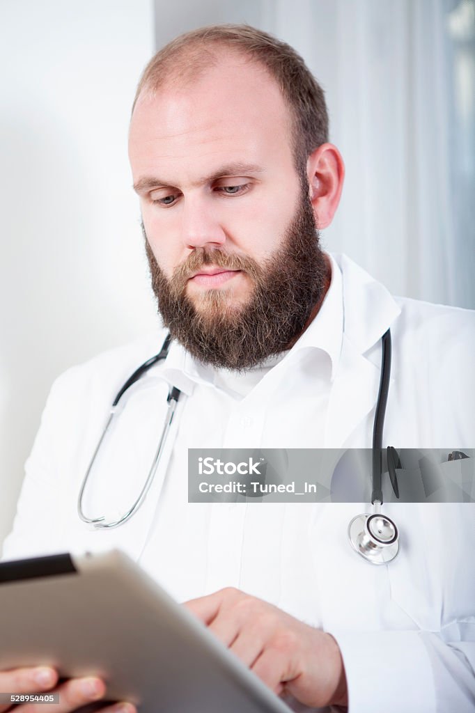 Portrait of a doctor with tablet computer Adult Stock Photo