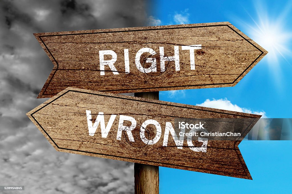 Right Or Wrong Right Or Wrong concept road sign with cloudy and sunny sky background. Advice Stock Photo