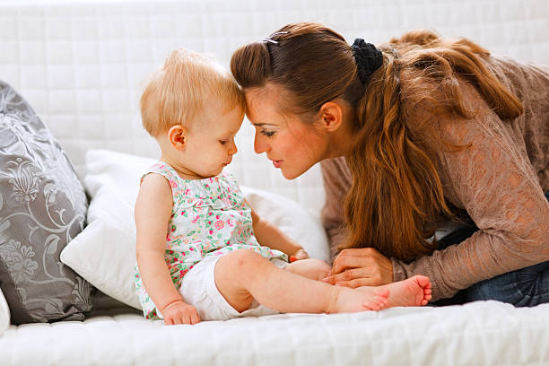 istock Young mother playing with her baby 528955519