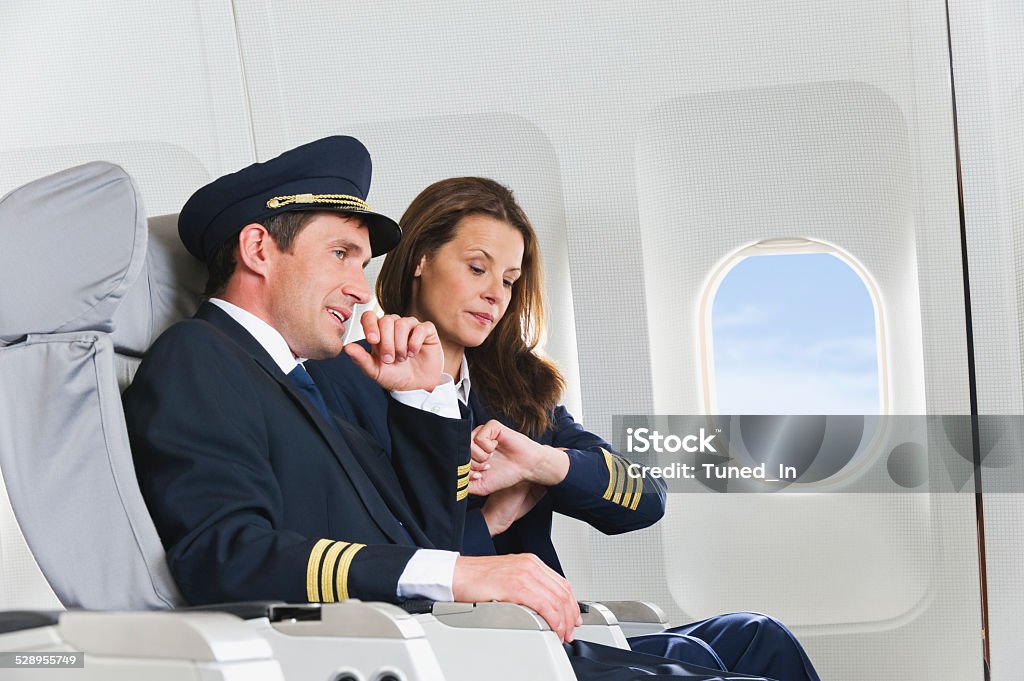 Flight personnel on airplane Adult Stock Photo