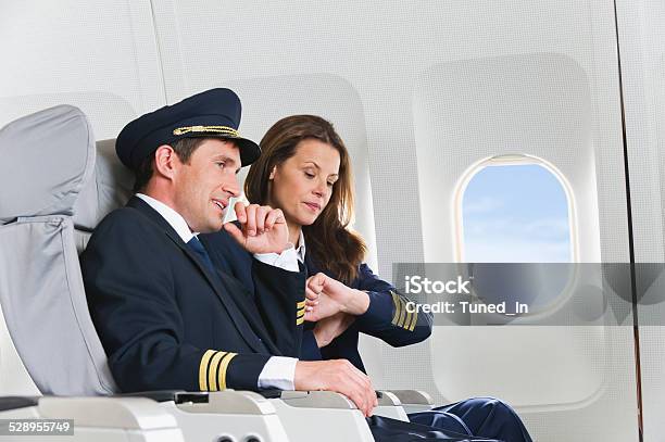 Flight Personnel On Airplane Stock Photo - Download Image Now - Adult, Adults Only, Air Stewardess