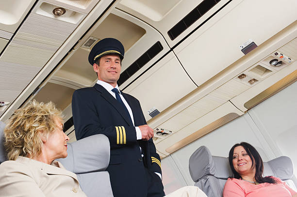istock Flight captain standing in between passengers of business class 528955767