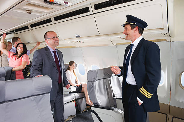 istock Flight captain talking with businessman on airplane 528955771
