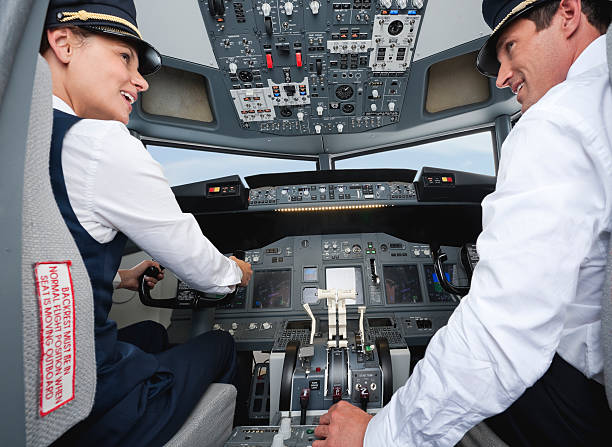 istock Pilot and co-pilot driving airplane in cockpit smiling 528955817