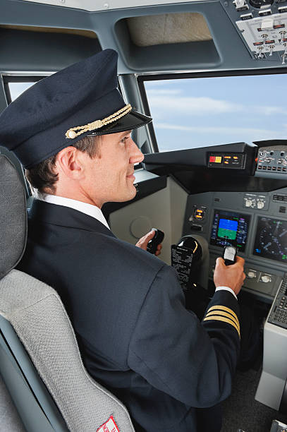 istock Pilot driving airplane in cockpit smiling 528955843