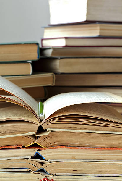 istock stacks of old opened books and pencil, closeup view 528957162