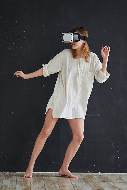istock Girl in a virtual reality helmet 528957600