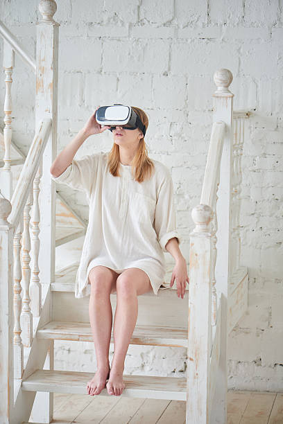 istock Girl in a virtual reality helmet 528957672