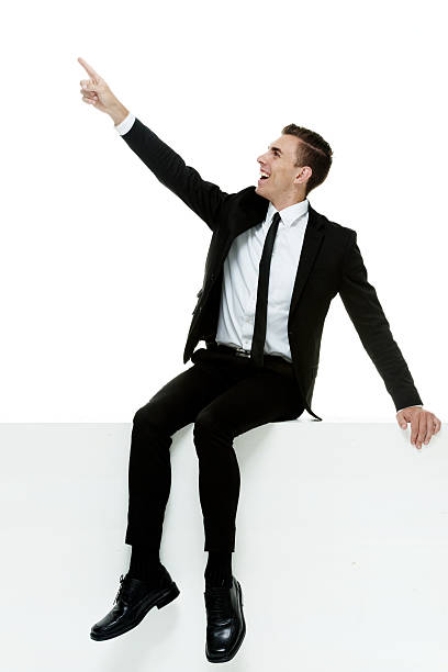 istock Smiling businessman pointing away 528957761