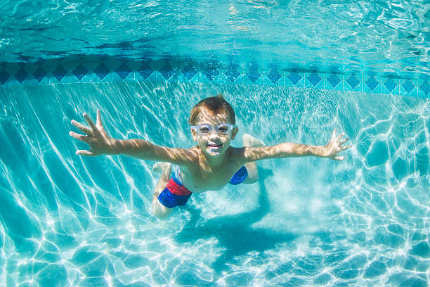 istock Young Boy Diving Underwater in Swimming Pool 528959183