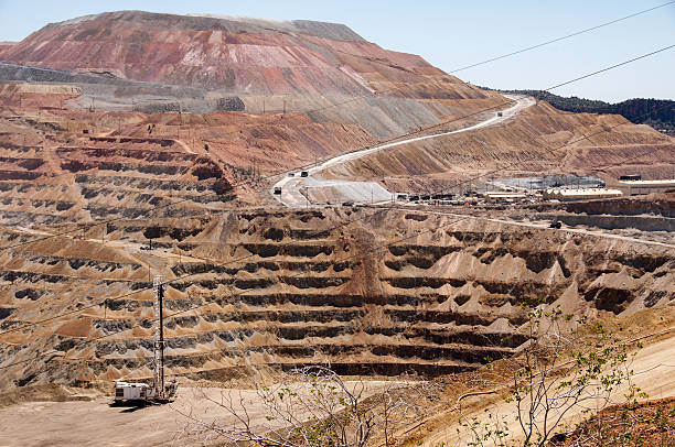 copper quarry reveals the raw beauty of Earth's geology, with rugged red rock formations stretching across the landscape.