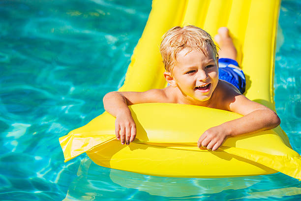 istock Boy Relaxing and Having Fun in Swimming Pool 528959723
