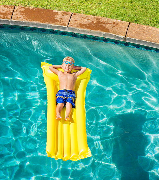 istock Boy Relaxing and Having Fun in Swimming Pool 528959729