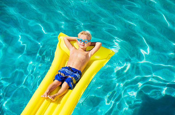 istock Boy Relaxing and Having Fun in Swimming Pool 528959733