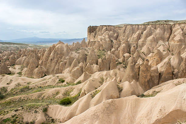 Cappadocia; also Capadocia; Turkish: Kapadokya is a historical region in Central Anatolia, largely in the Nevsehir, Kayseri, Aksaray, and Nigde Provinces in Turkey. The area is a popular tourist destination, as it has many areas with unique geological, historic, and cultural features. Touristic Cappadocia includes 4 cities: Nevsehir, Kayseri, Aksaray and Nigde. The most important towns and destinations in Cappadocia are Urgup, Goreme, Ihlara Valley, Selime, Guzelyurt, Uchisar, Avanos and Zelve. Among the underground cities worth seeing are Derinkuyu, Kaymakli, Gaziemir and Ozkanak. The best historic mansions and cave houses for tourist stays are in Urgup, Goreme, Guzelyurt and Uchisar. Hot-air ballooning is very popular in Cappadocia and is available in Goreme. Trekking is enjoyed in Ihlara Valley, Monastery Valley (Guzelyurt), Urgup and Goreme. The rocks of Cappadocia near Goreme eroded into hundreds of spectacular pillars and minaret-like forms. Horizontal composition. Outdoor shot.