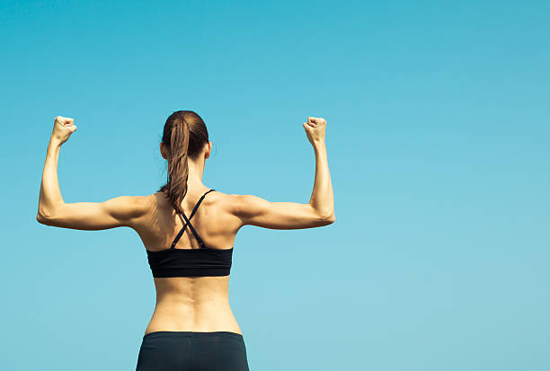 istock Portrait of strong female flexing. 528960174