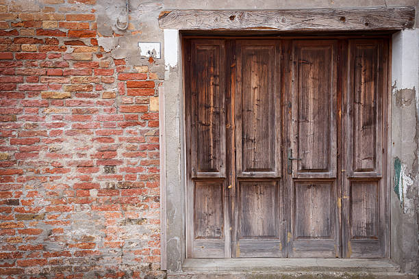 istock Old wooden locked door with peeling paint 528963546