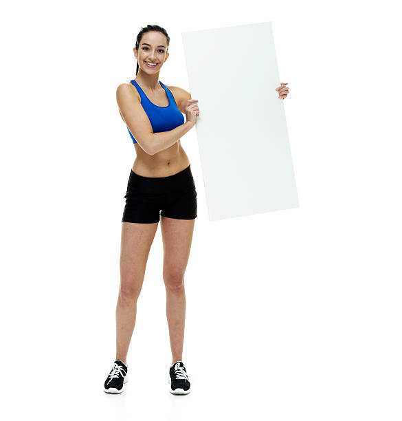 istock Smiling female holding placard 528964944