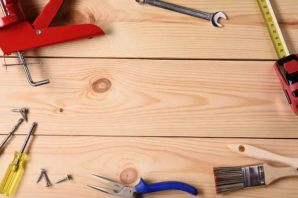 Carpentry, construction hardware tools on wooden planks. Top view, copy space.