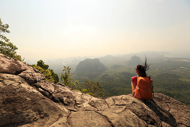 istock young woman backpacker hiking on seaside mountain peak 528970774