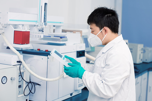 Senior male researcher carrying out scientific research in a lab