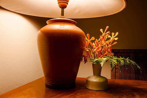 Vintage table lamp  light on wooden table with flowers .