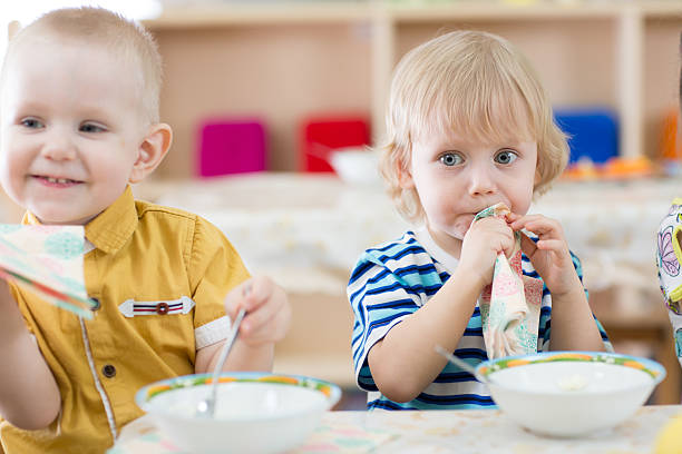 istock Funny children eating in kindergarten 528973382