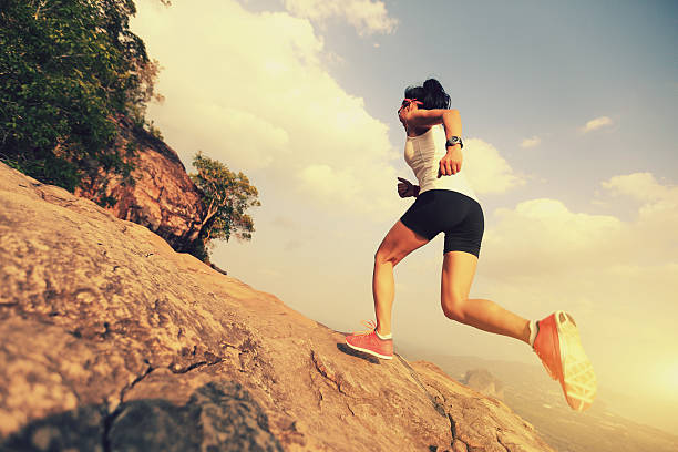 istock young woman trail runner running on mountain peak 528973428