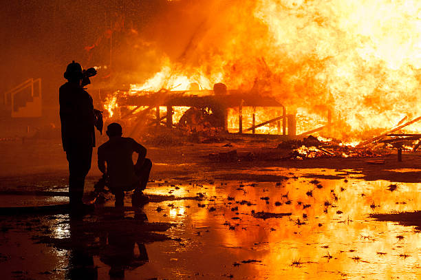 istock Silhouette of Firemen fighting a raging fire 528974138