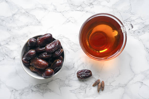 Dates fruit with cup of tea stock photo