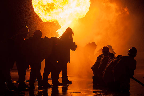istock Silhouette of Firemen fighting a raging fire 528975298