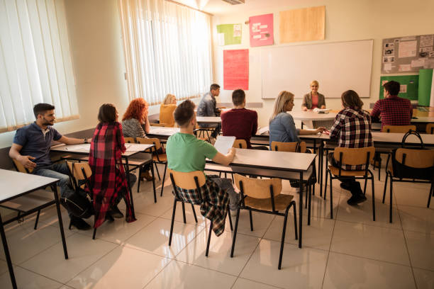 istock Group of students and teacher sitting in the classroom. 528977758