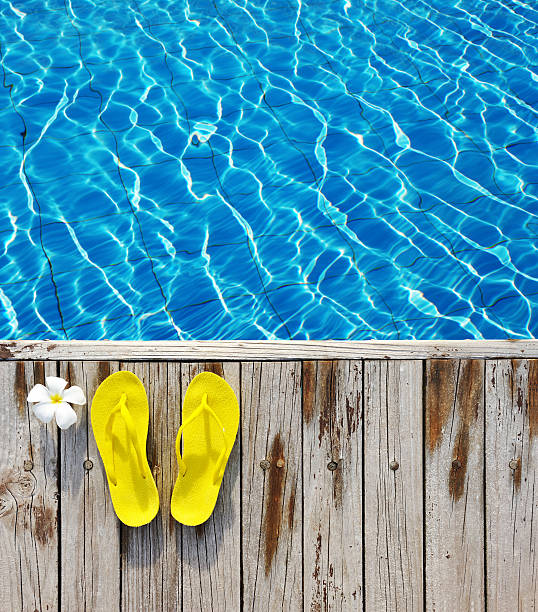 istock Flip-flops by a swimming pool 528978354