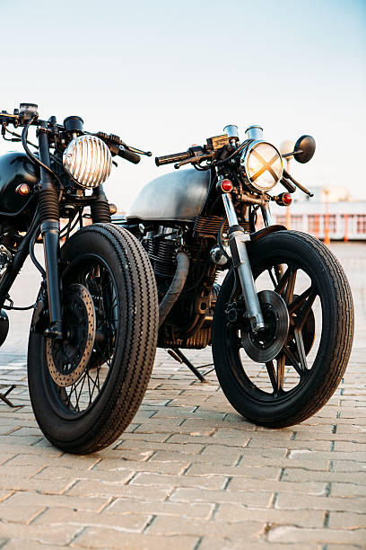 istock Two black and silver vintage custom motorcycles caferacers 528978504