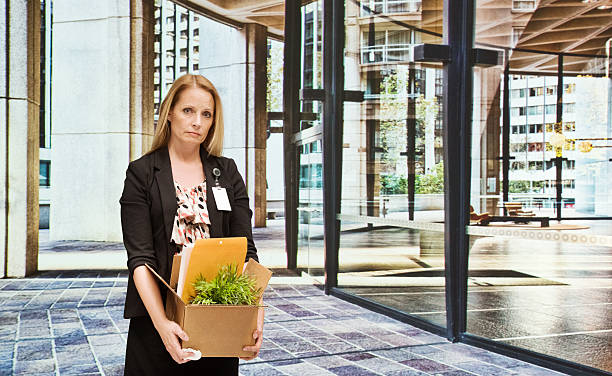 istock Sad businesswoman holding box in office 528979237