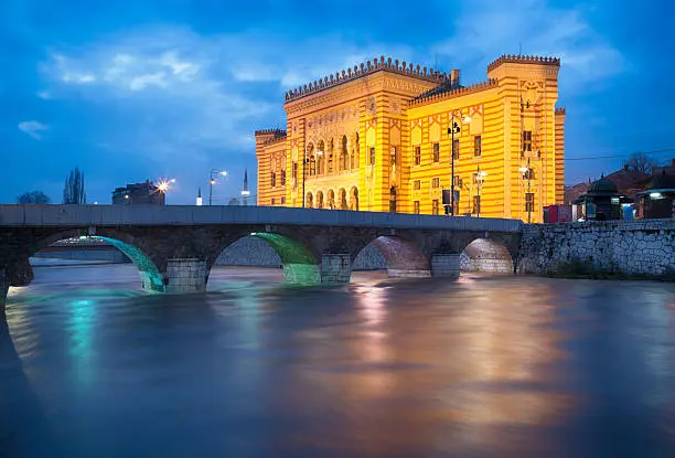 Long exposure image of Miljacka River, Seher-Cehaja Bridge (built in 1586) and City Hall or National Library (built in 1896) of Sarajevo, Bosnia.