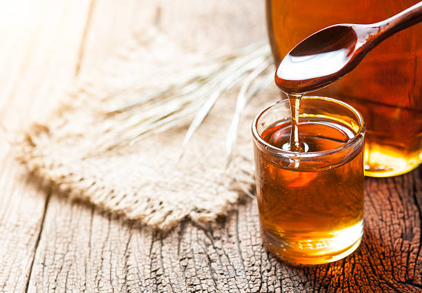 istock maple syrup in glass bottle on wooden table 528979500