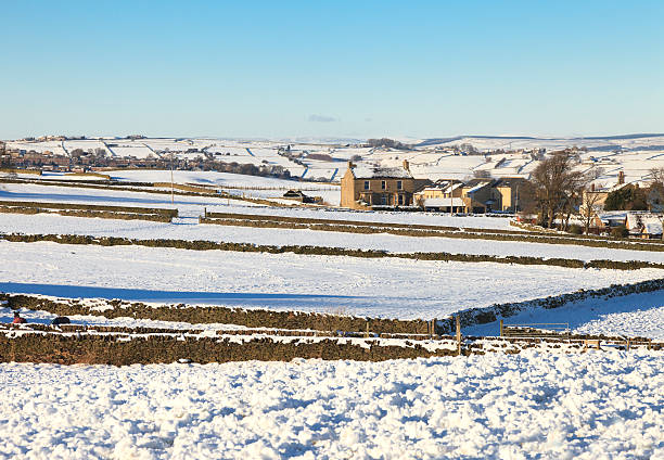A farm house in a rural winter setting. 