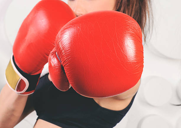 istock Woman boxer hit straight at the camera 528981738