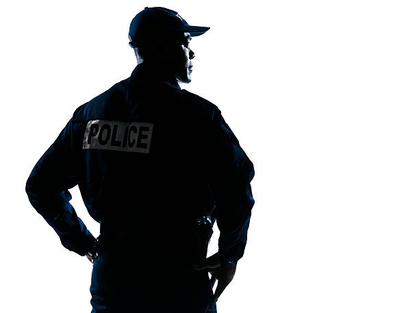Serious policeman with looking to his side silhouette
