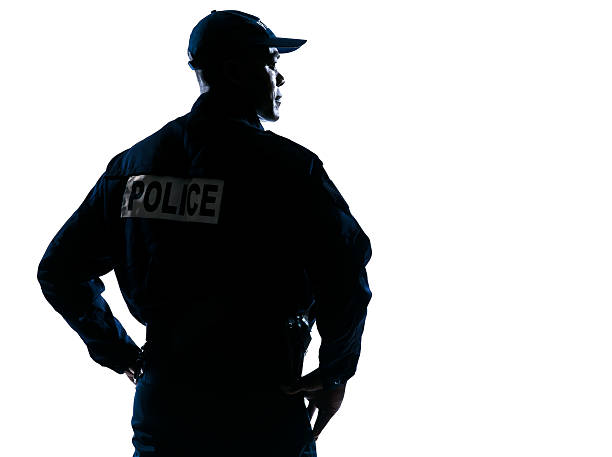 Serious policeman with looking to his side silhouette stock photo